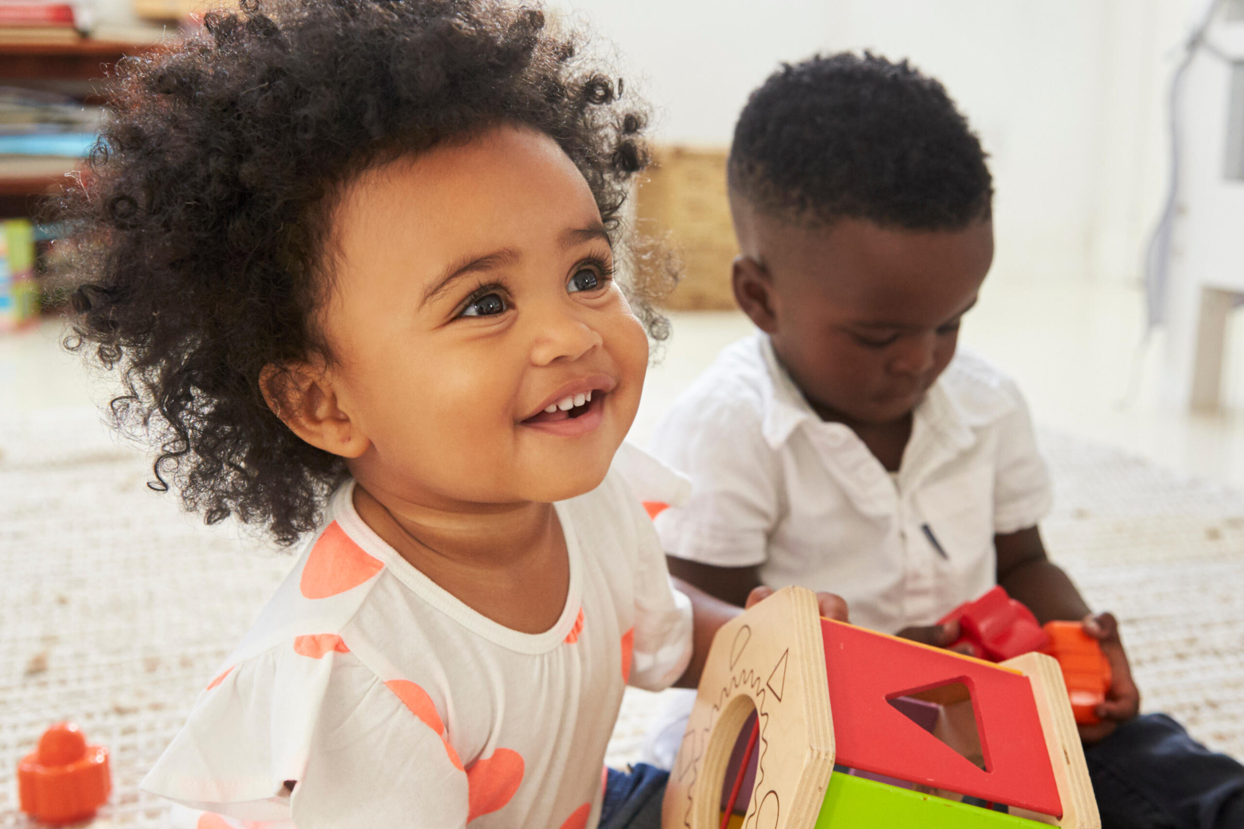 Family sitting outside with child holding phone